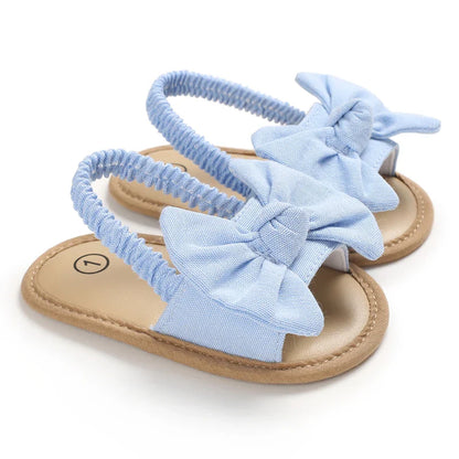 Soft sole baby shoes, red, with a durable cork bottom, designed for a baby girl's first walking adventures.