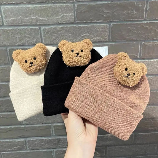 Cute cartoon bear knitted baby hat for winter warmth, unisex toddler accessory.