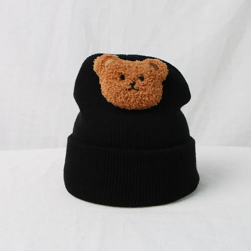 Winter-ready baby hat, handcrafted knitted design with a charming bear face.