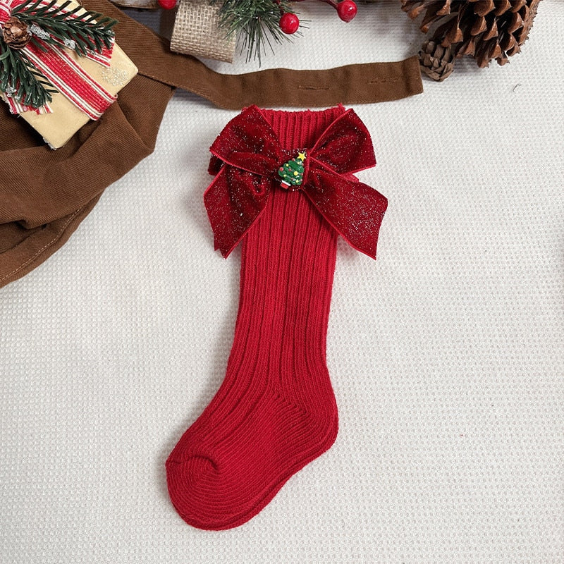 Red and white striped anti-slip socks with a Santa hat character for kids