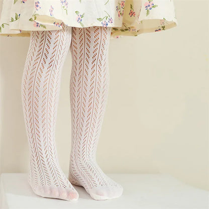 Child playing in breathable mesh thin summer pantyhose, perfect for active kids.