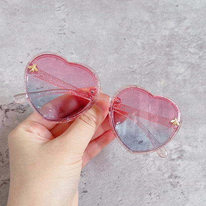 A pair of vibrant yellow heart-shaped sunglasses for girls, a cute accessory and kids gift with UV protection