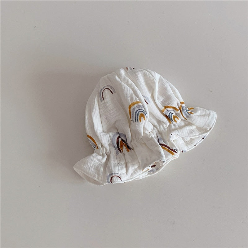 Baby wearing a stylish blue cotton beanie hat, an all-season kids' accessory and baby gift.