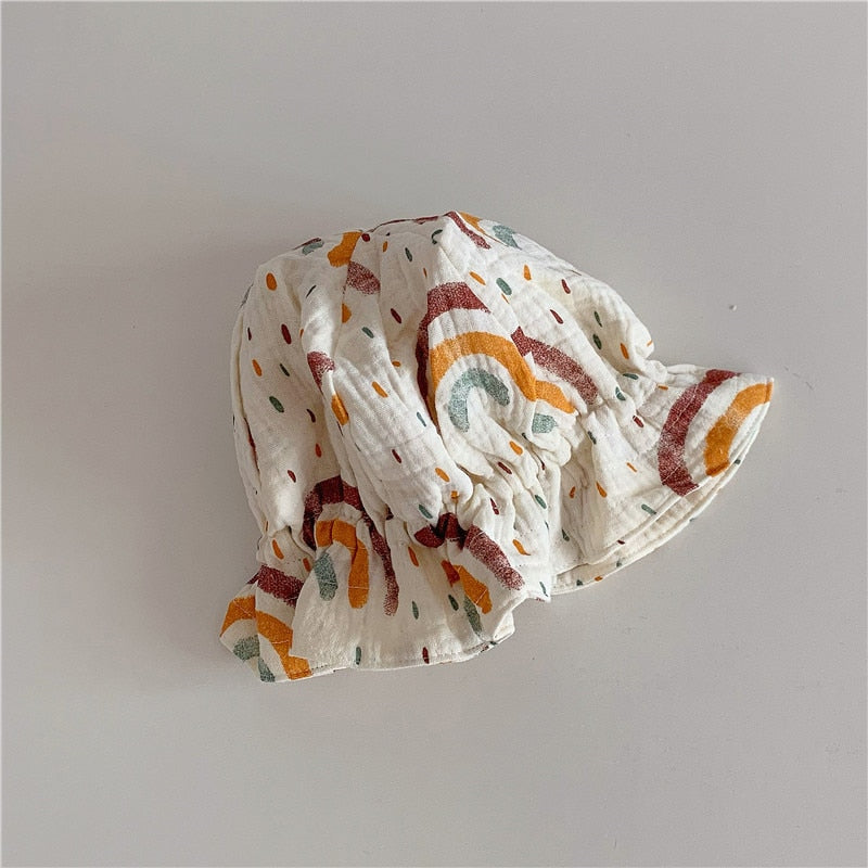 Toddler with a mustard yellow cotton beanie, a versatile kid's hat and stylish baby accessory.