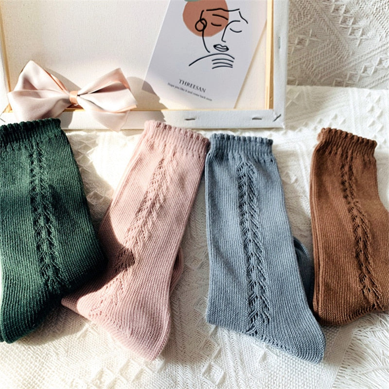 Kids' knee-high cotton blend socks displayed neatly, showing various colors and designs.