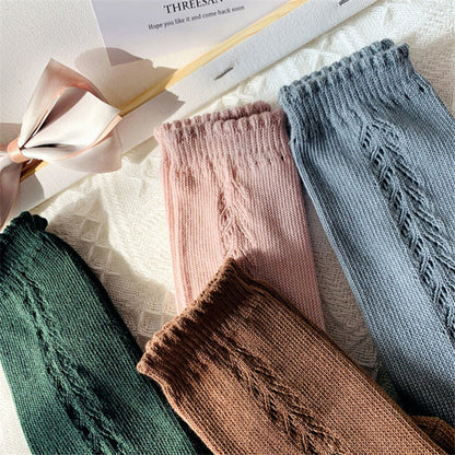 Stack of colorful knee-high cotton blend socks, essential children's apparel.
