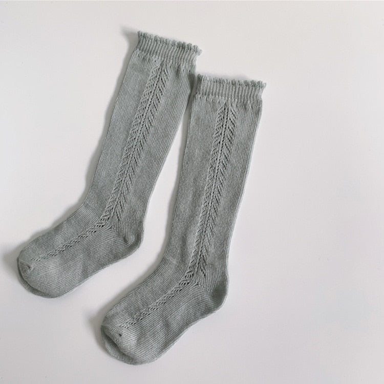 Children's knee-high cotton blend socks with fun stripes, ideal for active kids.