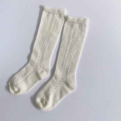 Toddler knee-high cotton blend socks with animal patterns, keeping little feet warm.