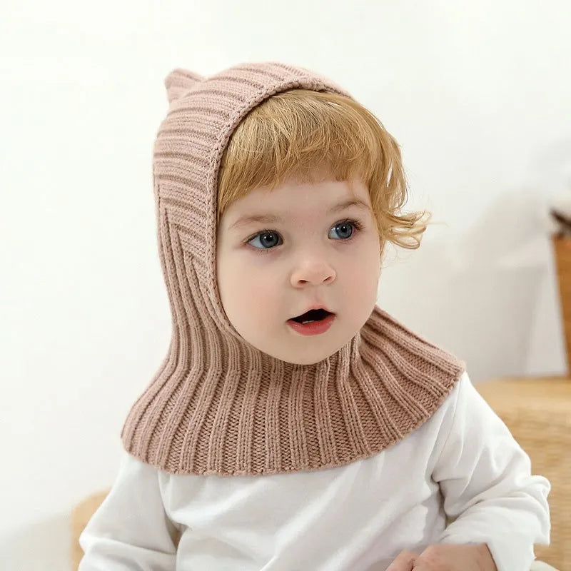 Cozy knitted baby hat with a ribbed cuff, designed for warmth and comfort, unisex toddler winter wear.