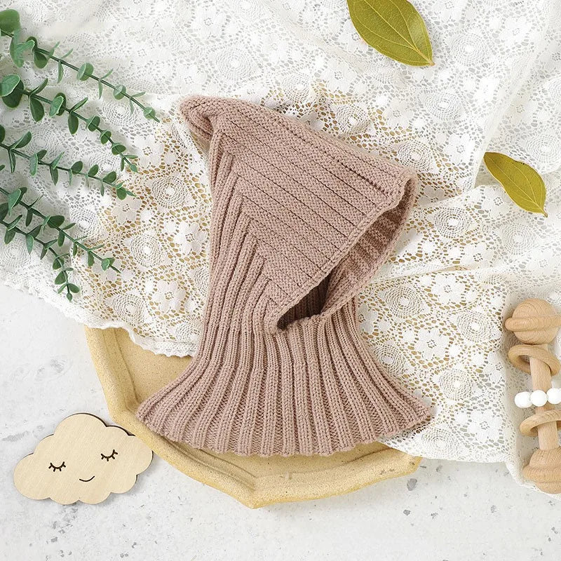 Close-up of a warm knitted baby winter hat, showcasing its soft acrylic material and detailed stitching.
