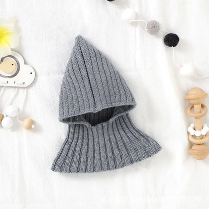 Unisex baby winter hat on a plain background, highlighting its knitted texture and simple, warm design.