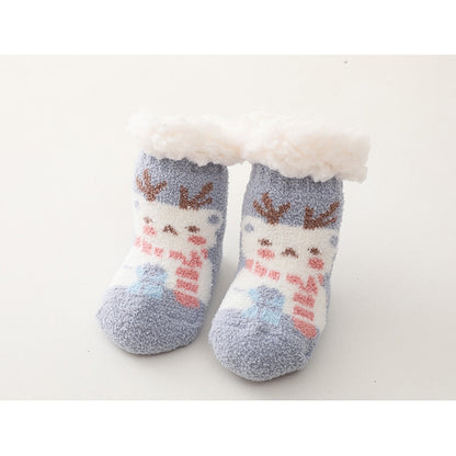 Close-up of anti-slip grippers on the sole of white baby thick cotton socks, for active infants.