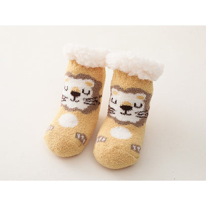 Toddler wearing grey baby thick cotton anti-slip socks, playing on a wooden floor, comfort and safety.
