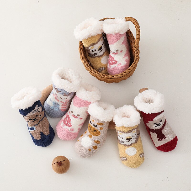 Infant feet in striped baby thick cotton anti-slip socks, keeping warm and preventing slips.