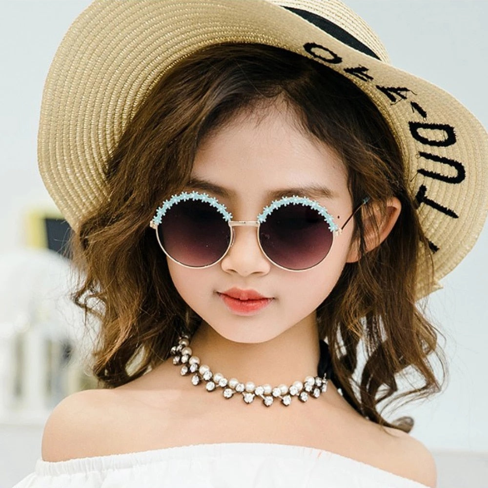 Cute pink kids sunglasses with UV protection for sunny outdoor play, flexible frames