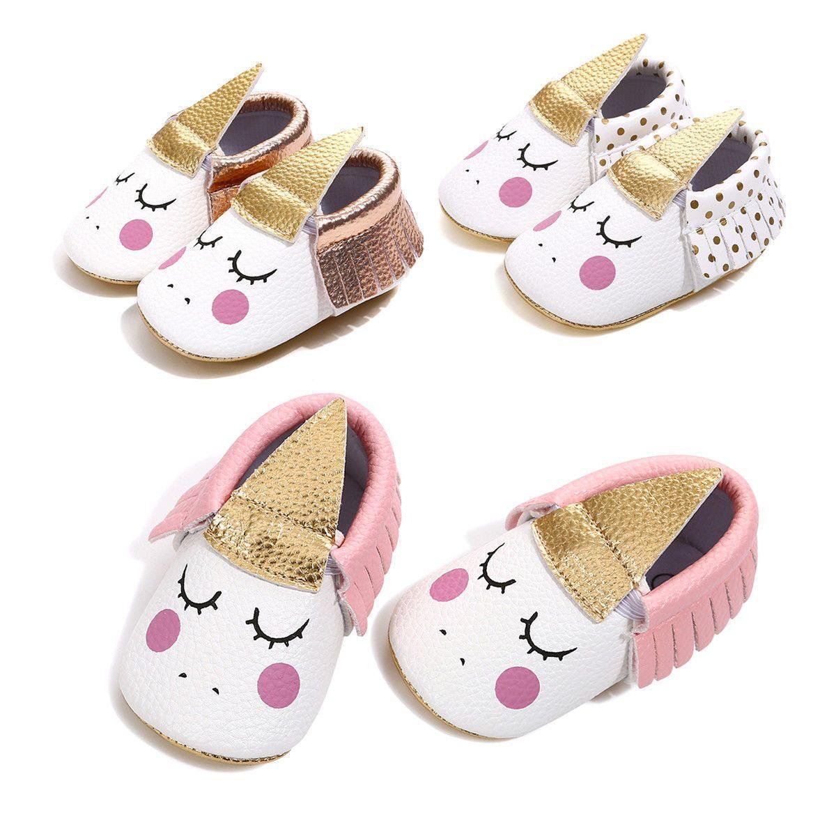 Close-up of a baby girl's unicorn shoe featuring a soft, non-slip sole and colorful design.