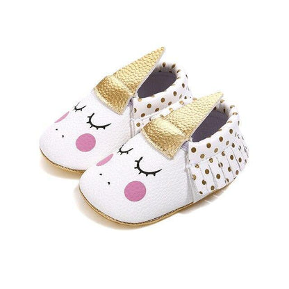 Side view of a baby girl's non-slip unicorn shoe, showing the durable, flexible sole.