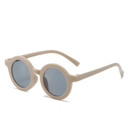 Trendy round kids sunglasses, gray frame, UV protective lenses, modern toddler fashion accessory