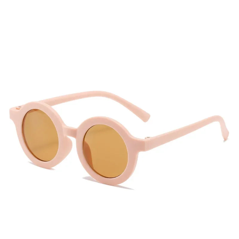 Adorable toddler wearing purple round sunglasses, UV protection, enjoying outdoor play