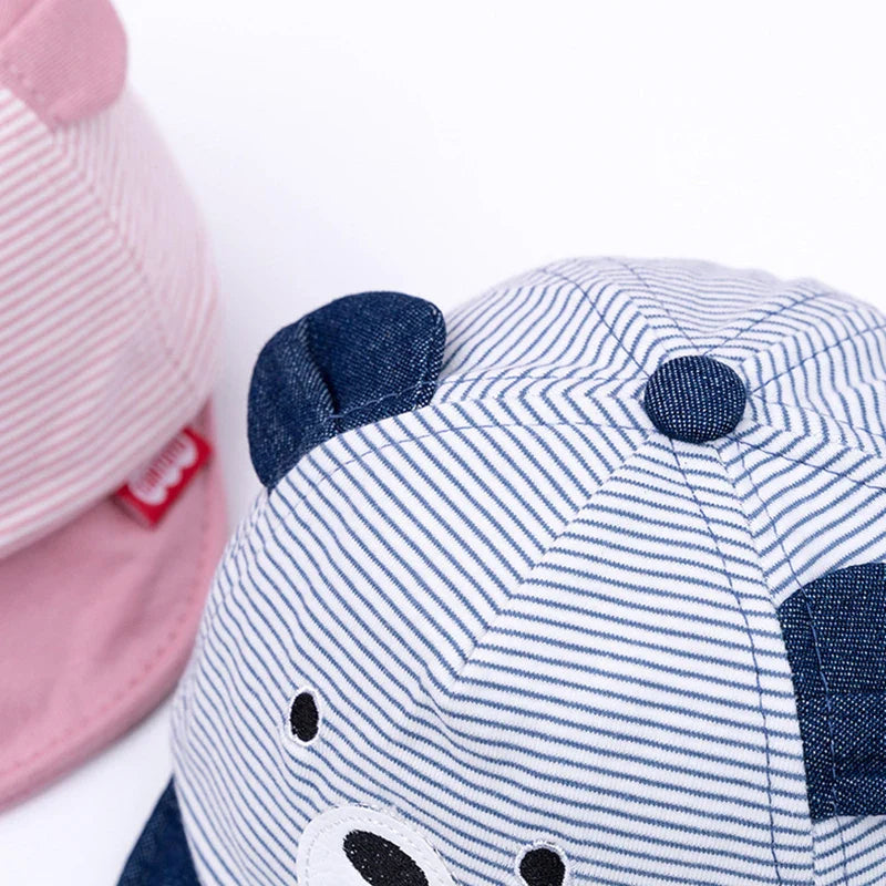 Close-up of a baby cap featuring a cheerful cartoon monkey, adjustable cotton for all seasons