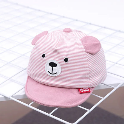 Baby model showcasing an adjustable cartoon animal baby cap, comfortable all-season infant cotton hat