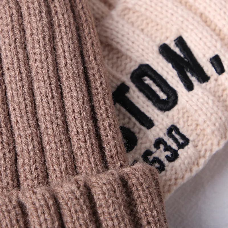 Adorable cream knitted baby hat with 'D', a cozy accessory for newborn to 5-year-olds