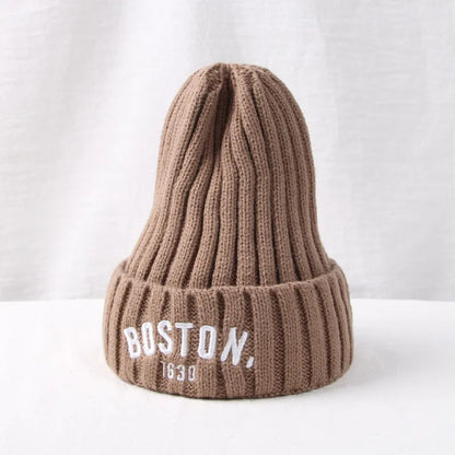Green knitted toddler hat with 'G' letter, a cute and functional cold-weather accessory