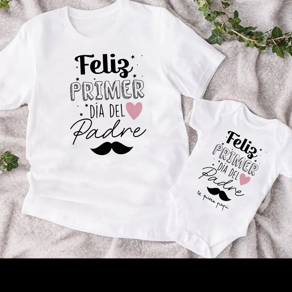 Stylish dad and baby in coordinated heart print short sleeve tops, family matching clothes