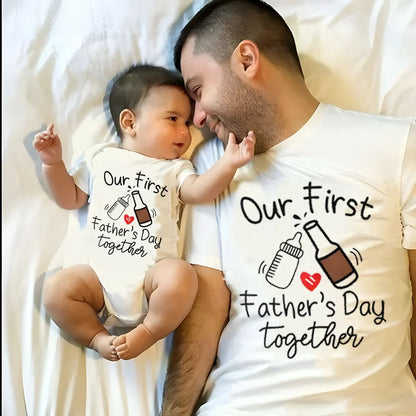 New dad proudly holding baby, both in matching 'First Father's Day' summer outfits.