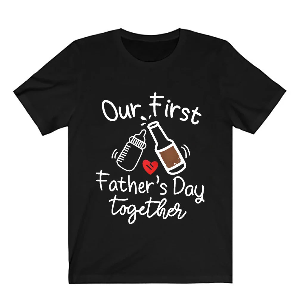 Happy father and baby in matching 'First Father's Day' daddy and me apparel, outdoor setting.