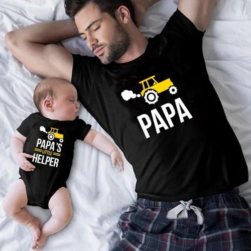Close-up of a father and his toddler son wearing 'Papa' and 'Little Helper' matching cotton blend tees.