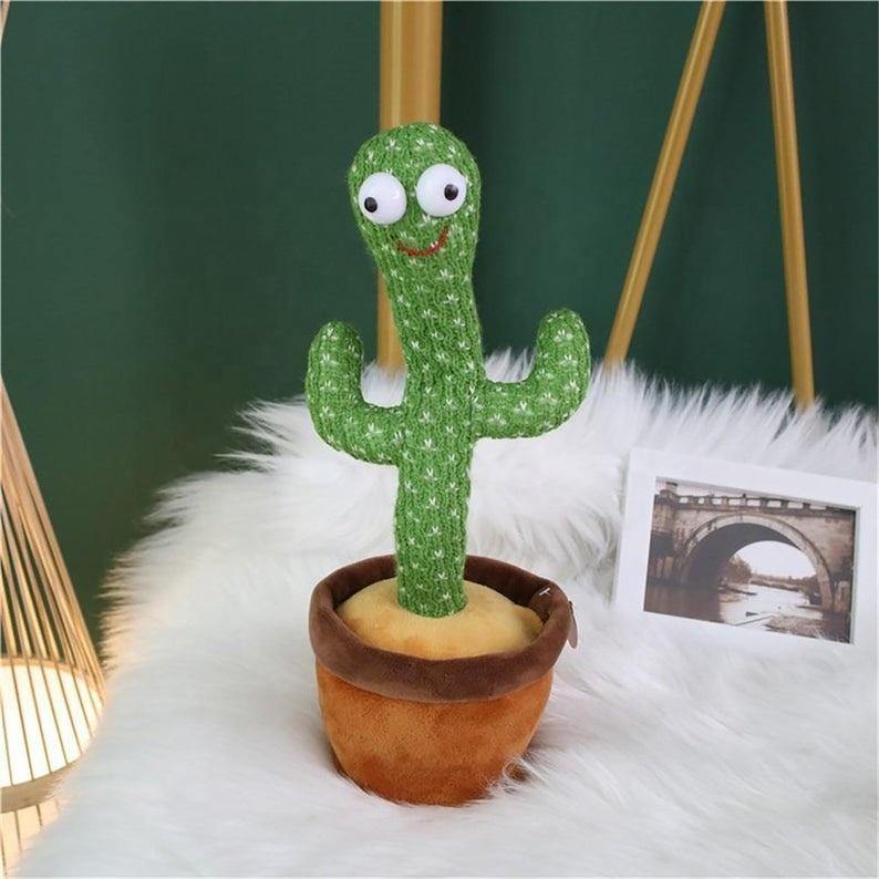 Happy child playing with a Dancing Cactus, its arms raised as if dancing, a fun kids toy
