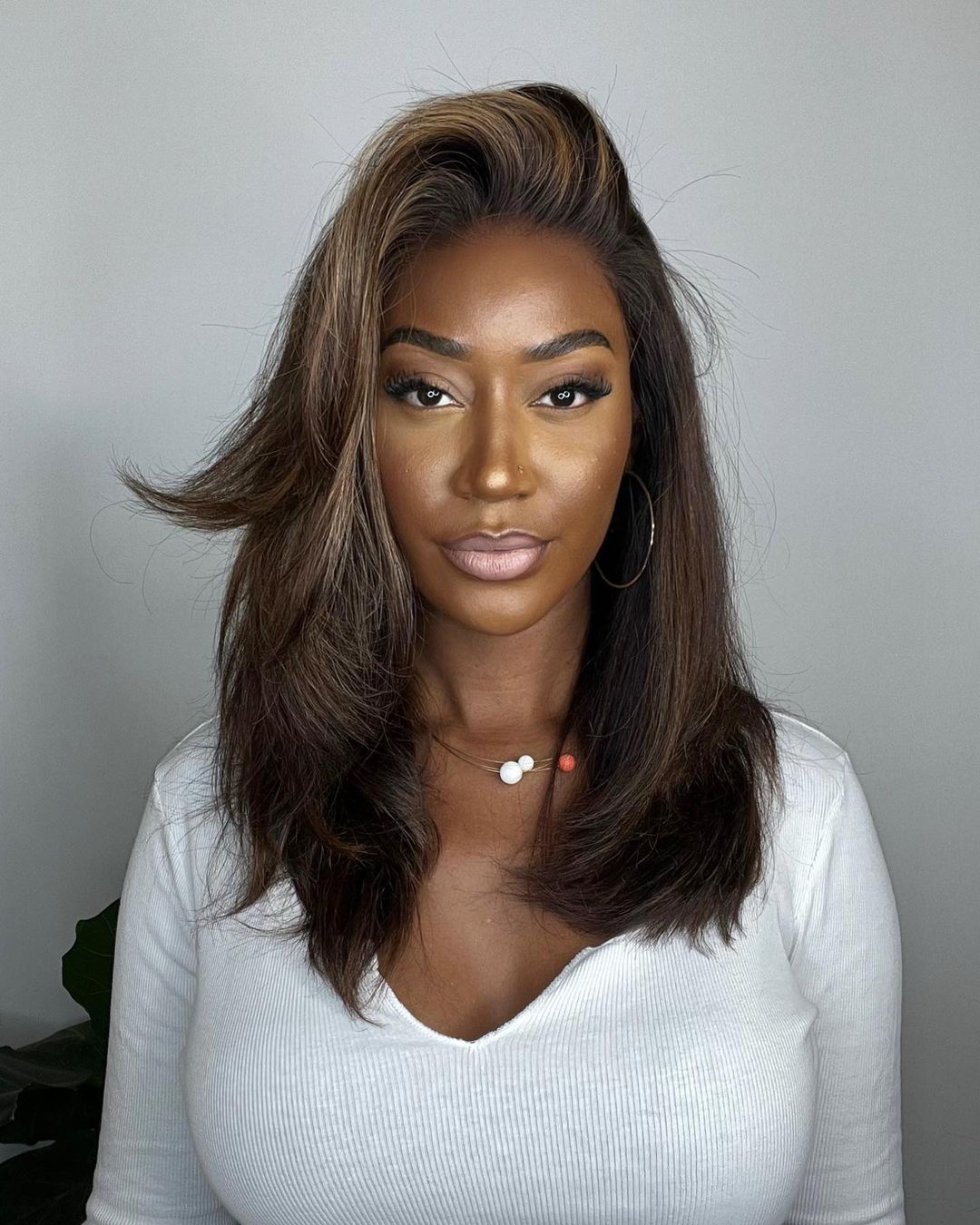 Elegant wavy highlighted lace front wig for women. Dark brown human hair with blonde accents, natural hairline, full density.