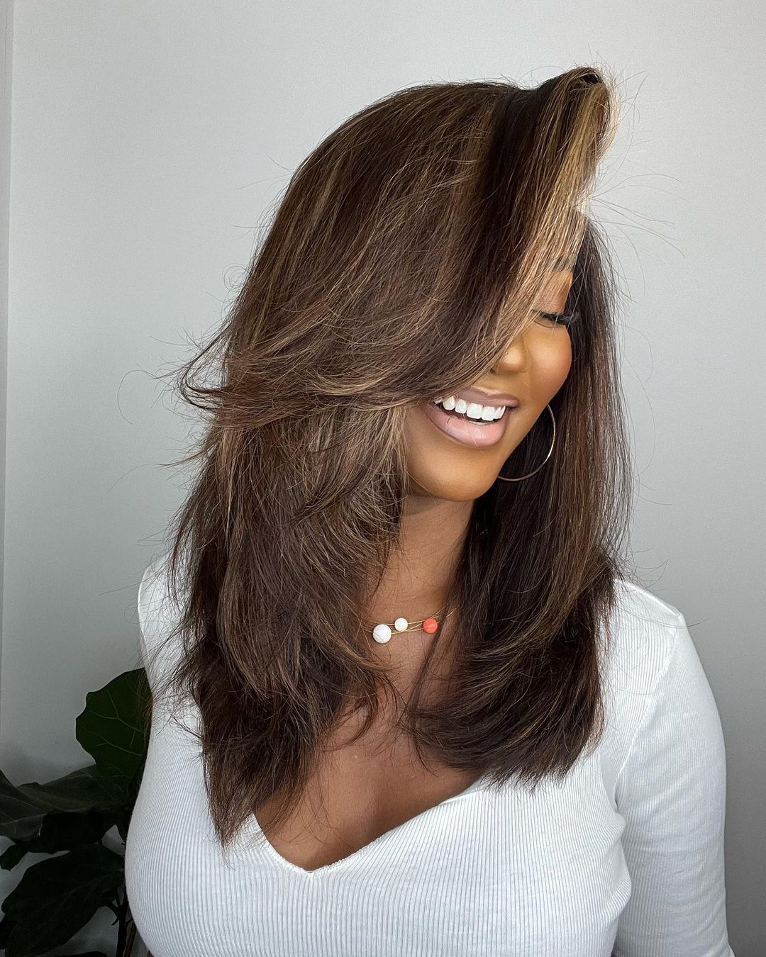 Wavy dark brown human hair lace front wig with natural blonde highlights. Perfect for women seeking a stylish look.