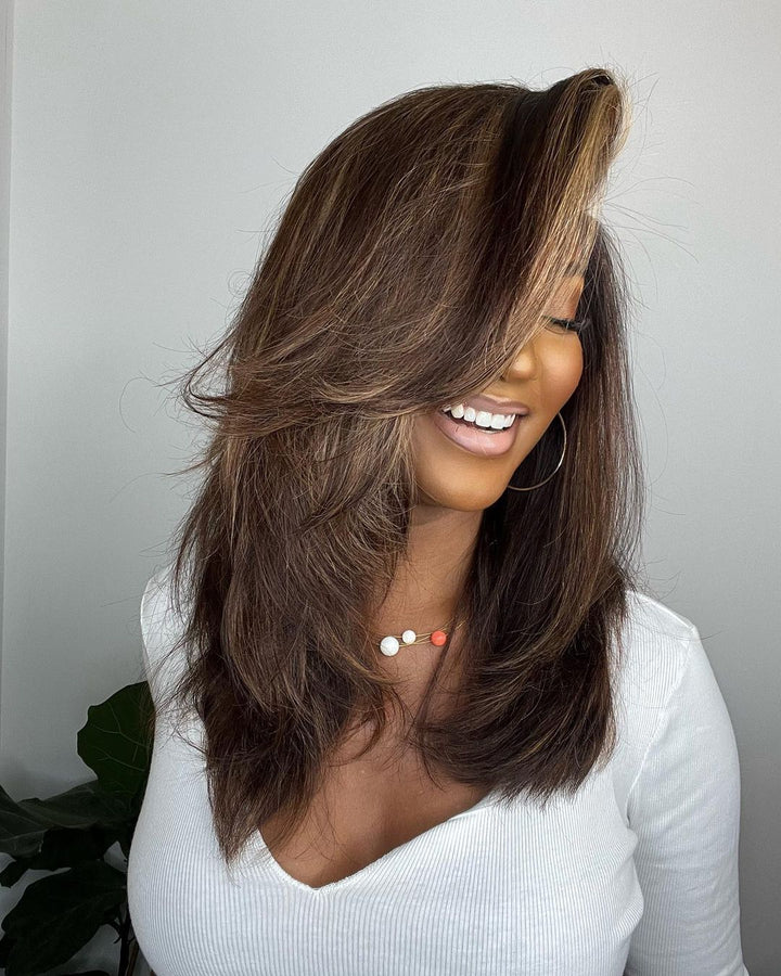 Wavy dark brown human hair lace front wig with natural blonde highlights. Perfect for women seeking a stylish look.