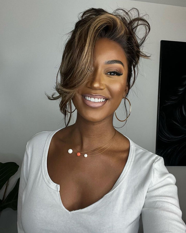Women's dark brown wavy human hair lace front wig with blonde highlights, natural hairline, and full density for style.