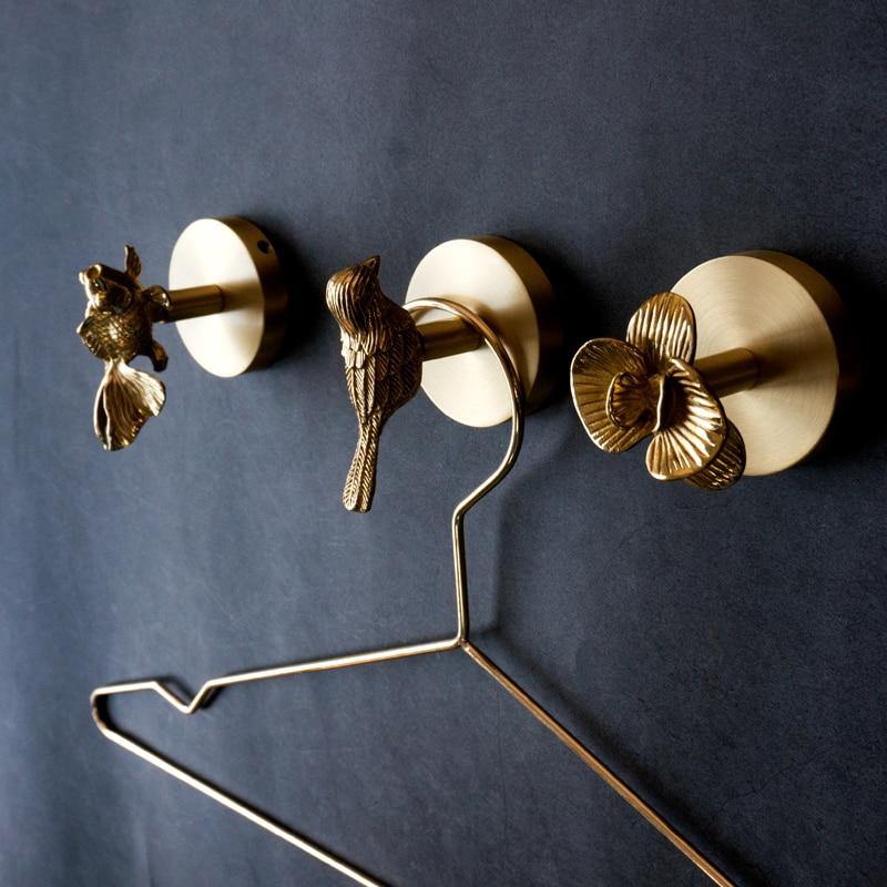Stylish gold finish animal wall hook, perfect for coats, bags in modern home decor.