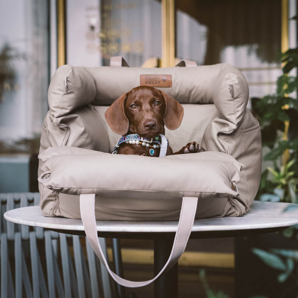 Deluxe pet booster seat for car travel; comfortable dog bed ensures safety & coziness.