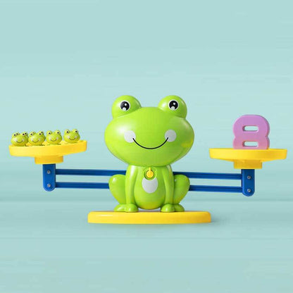 Close-up of a dinosaur balance scale showing numeric weights for math games