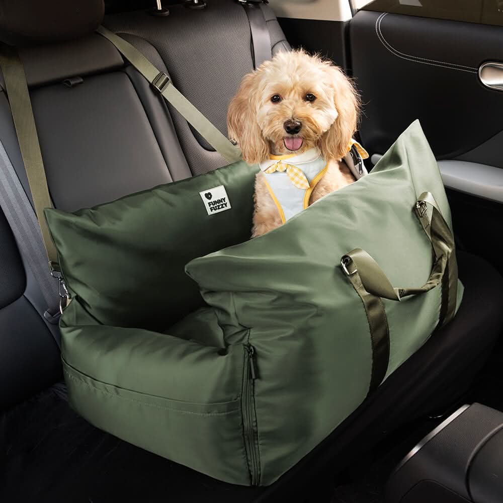 Small pet booster car seat with safety harness connection for added security.