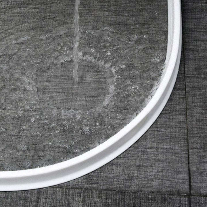 DryGuard shower water stopper for a dry bathroom, made from durable, easy-to-clean silicone.