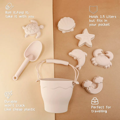 Kids' outdoor play set: soft green silicone beach bucket, spade, and fish sand mold, sustainable toys.