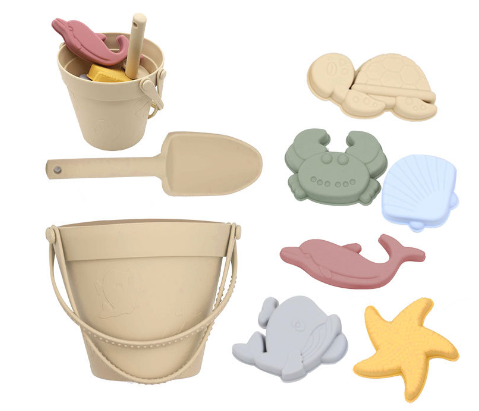 Eco-friendly silicone sand toys for kids, a yellow bucket and rake shown on a sandy beach background.