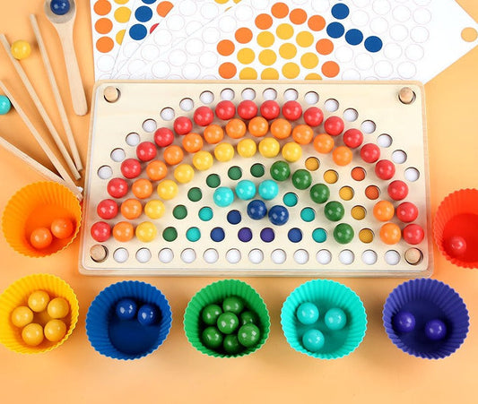 Educational wooden rainbow bead stacking toy with tweezers for fine motor skills development, top view.
