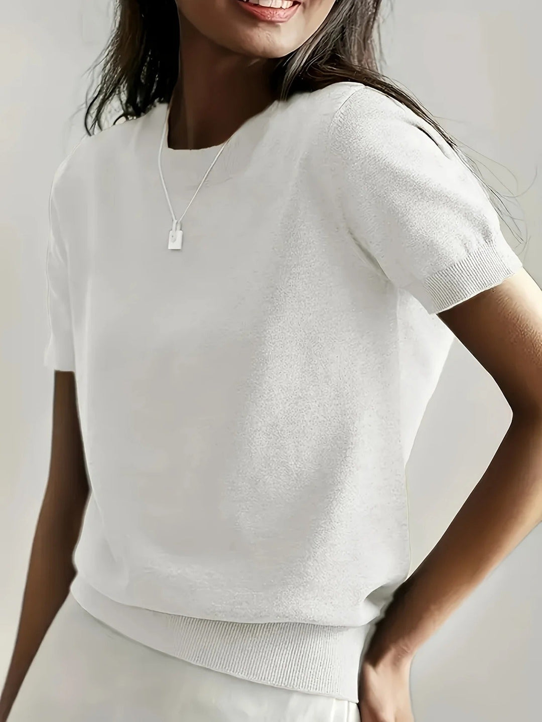 Relaxed women's crew neck short sleeve top, comfortable knit for everyday wear.