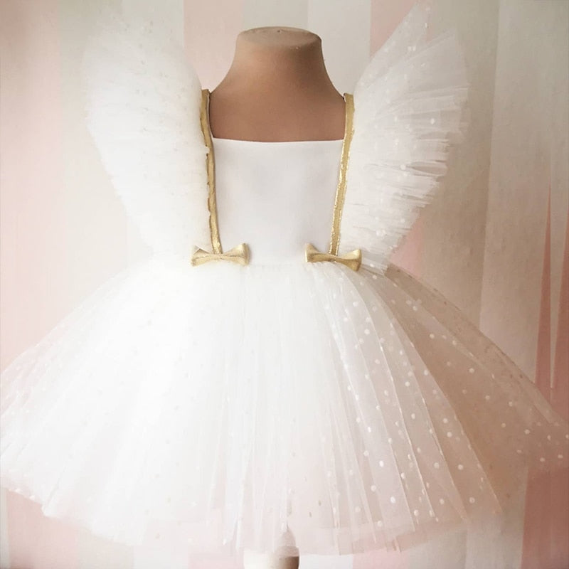 Pretty baby girl dress featuring fashionable puffy mesh sleeves and a classic knee-length silhouette.