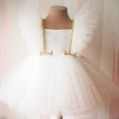 Pretty baby girl dress featuring fashionable puffy mesh sleeves and a classic knee-length silhouette.