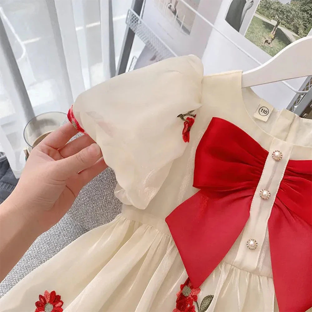 Full-length view of a toddler's elegant beige summer dress, featuring a classic princess silhouette.