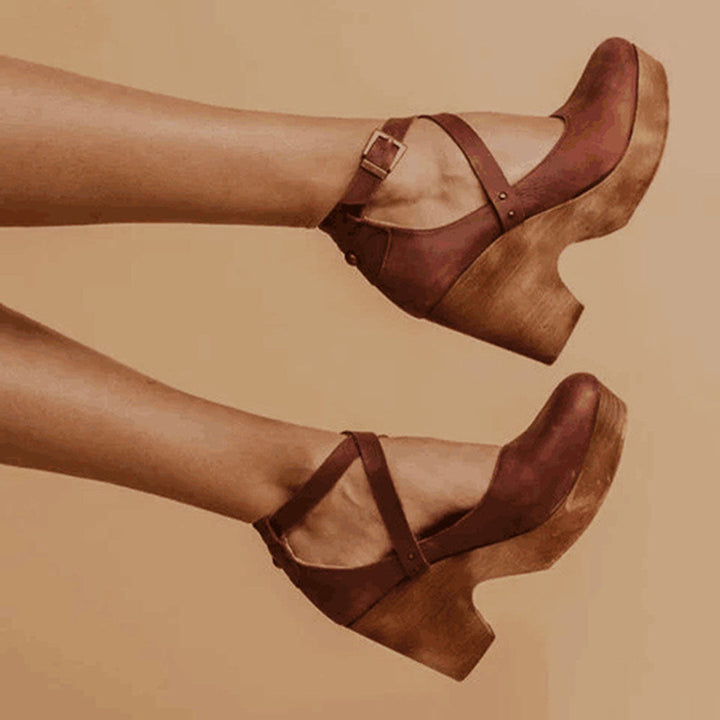 Stylish women's brown wedge heels with closed toe, comfortable & elegant footwear for versatile dress shoe occasions.