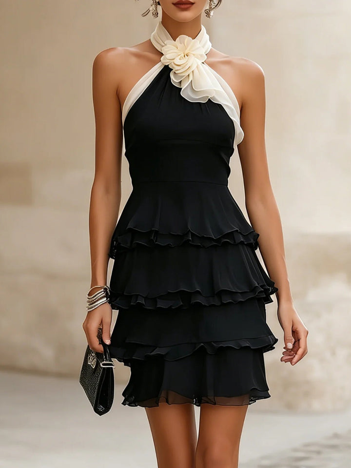 Elegant black halter mini dress with rosette & ruffles. Perfect cocktail or party wear for women.
